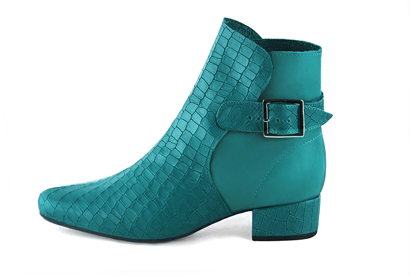Turquoise blue women's ankle boots with buckles at the back. Round toe. Low block heels. Profile view - Florence KOOIJMAN